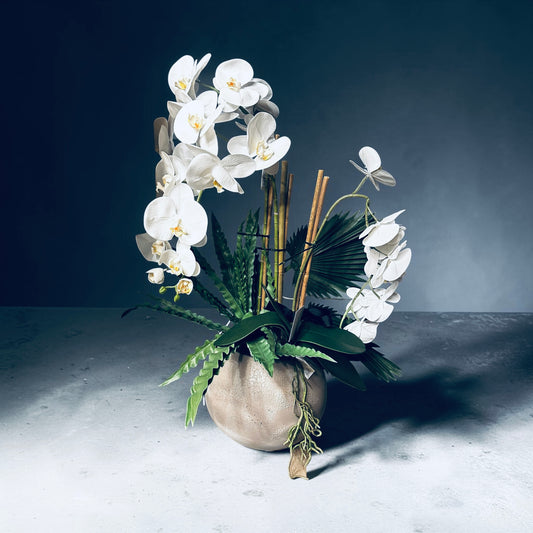 The dolce real touch white artificial orchid with mixed foliage